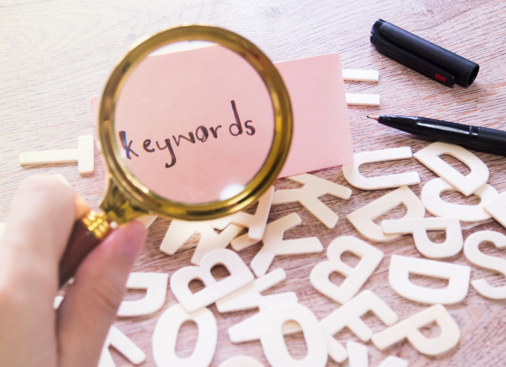 How do keywords help enhance your website performance?
